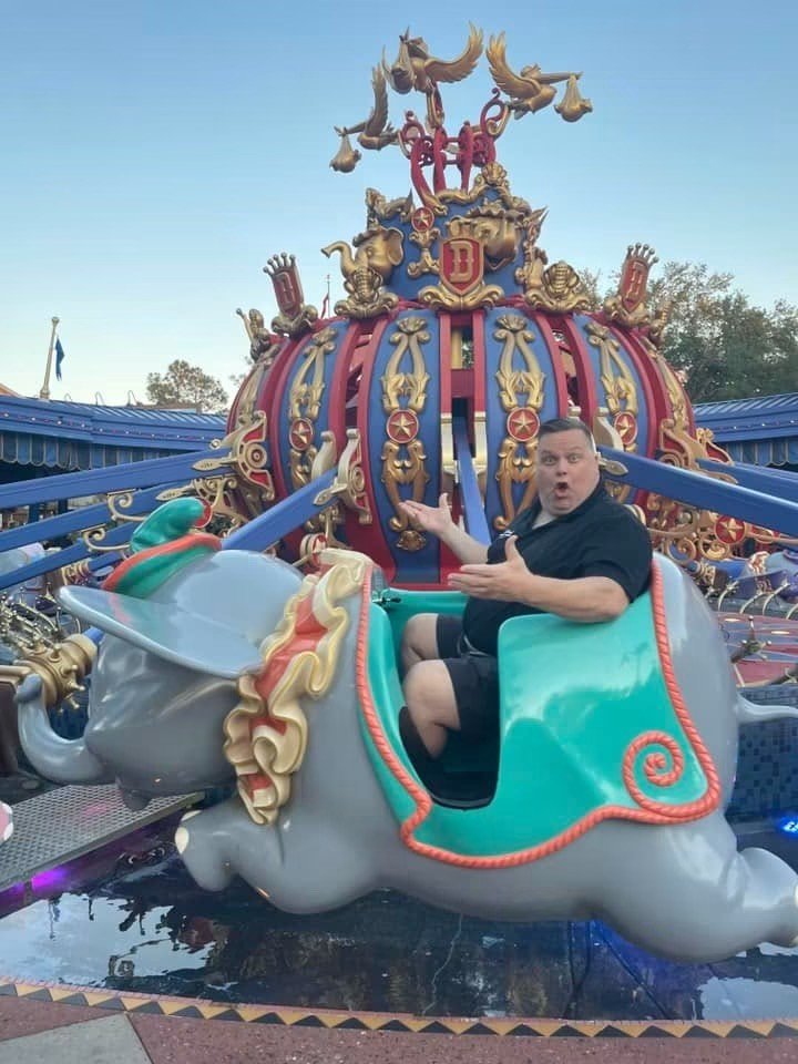 Kris laughing on the Dumbo ride